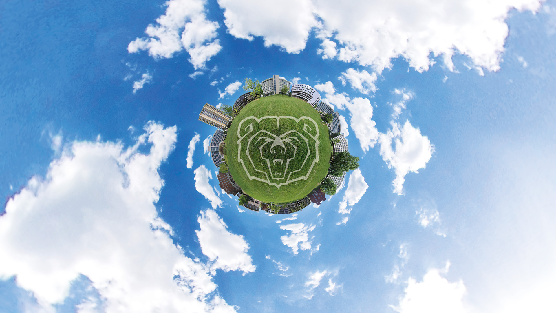 Photo collage of residence halls surrounding a tiny grass planet floating in a blue sky with clouds
